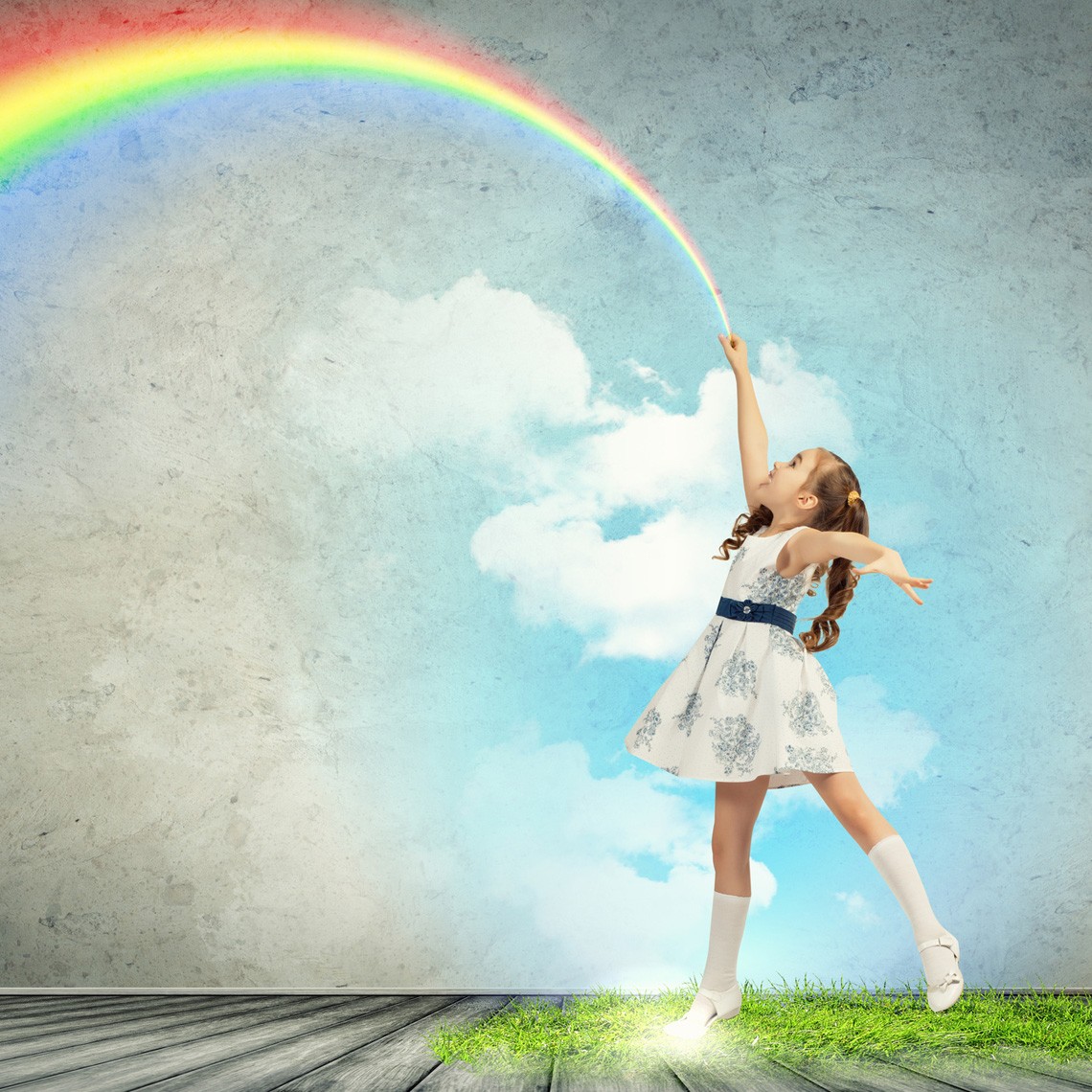 little girl drawing rainbow